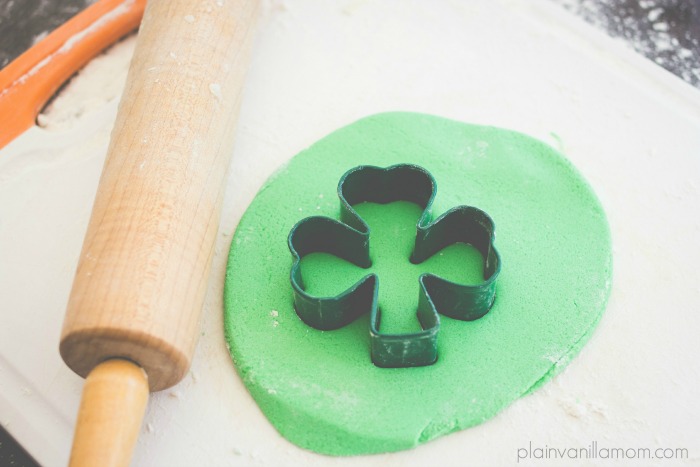 Use shamrock cookie cutter to cut shamrocks for glittered salt dough shamrock bouquet.